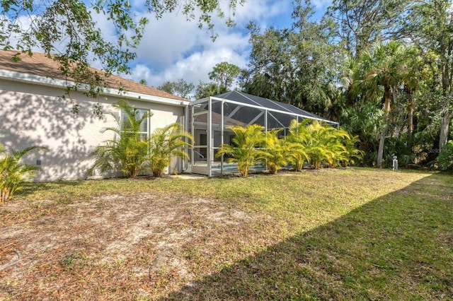 view of yard with glass enclosure