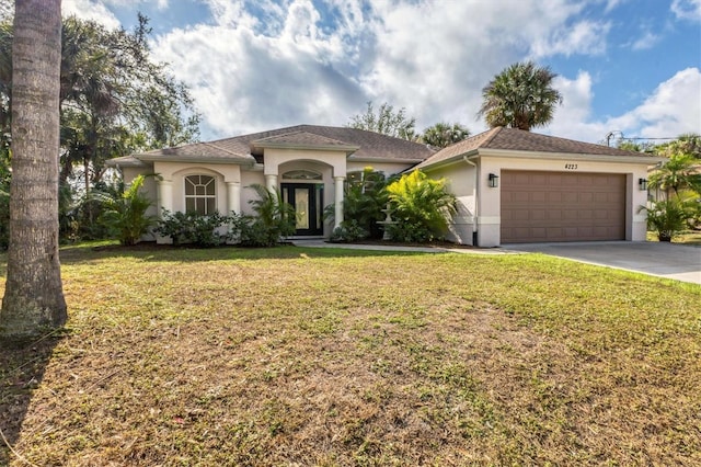 view of front of house with a front yard and a garage