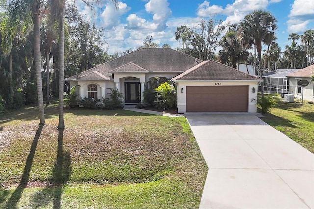 view of front of property with a front yard and a garage