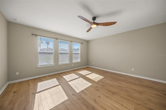 unfurnished room with ceiling fan, a textured ceiling, and light hardwood / wood-style floors