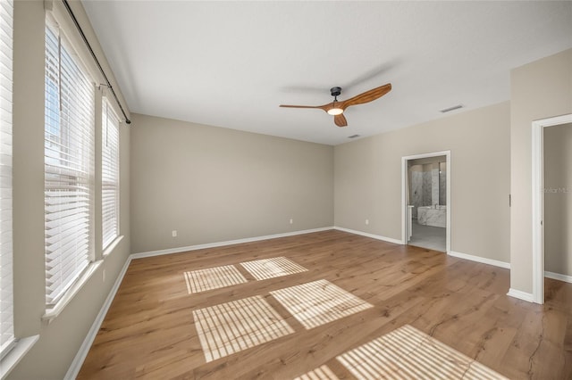 unfurnished bedroom with ensuite bathroom, ceiling fan, and light hardwood / wood-style flooring