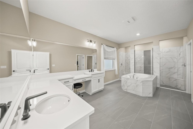 bathroom with vanity and shower with separate bathtub