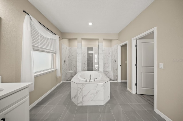 bathroom featuring shower with separate bathtub and vanity