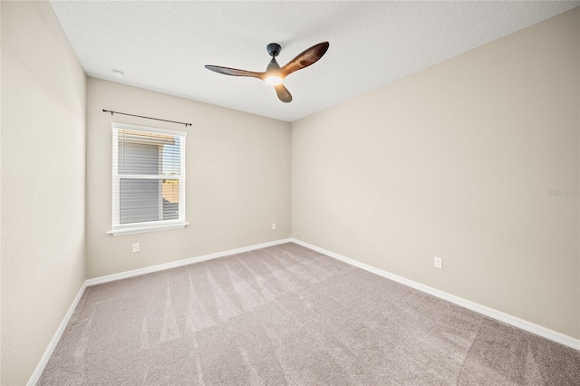 carpeted empty room with ceiling fan and a textured ceiling