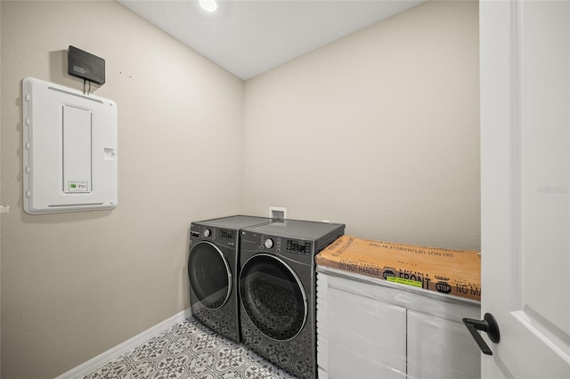 clothes washing area with light tile patterned flooring and independent washer and dryer