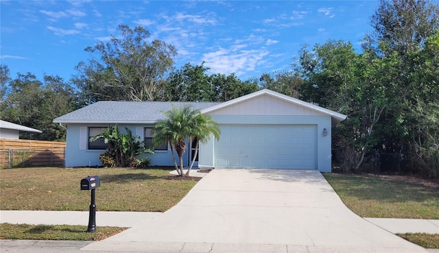 ranch-style home with a garage and a front lawn