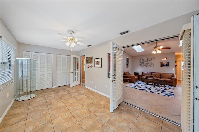 interior space with french doors and ceiling fan