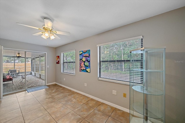 empty room featuring ceiling fan and light tile patterned floors