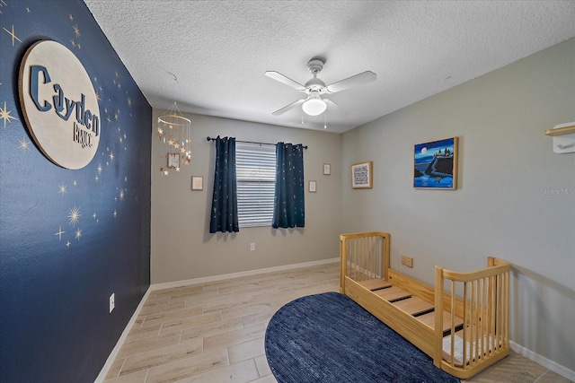 bedroom featuring a textured ceiling, ceiling fan, and light hardwood / wood-style flooring