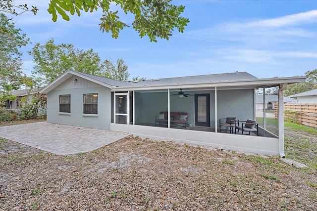 rear view of house featuring a sunroom, ceiling fan, and a patio area