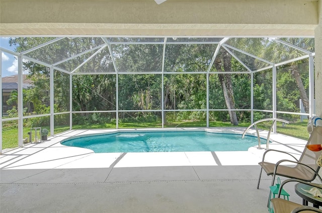 view of swimming pool with a lanai and a patio area