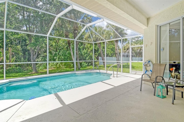 view of swimming pool featuring a lanai and a patio