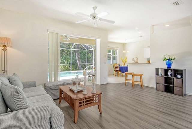 living room featuring hardwood / wood-style flooring and ceiling fan