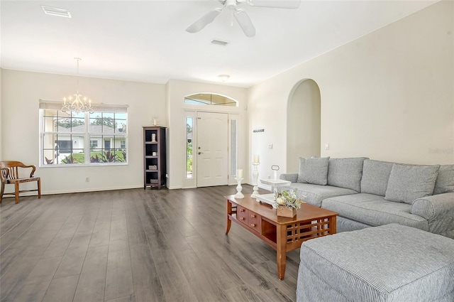 living room featuring ceiling fan with notable chandelier and hardwood / wood-style flooring