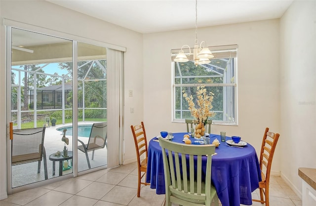 dining room featuring a chandelier, light tile patterned floors, and plenty of natural light