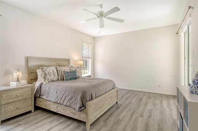 bedroom with ceiling fan and light wood-type flooring