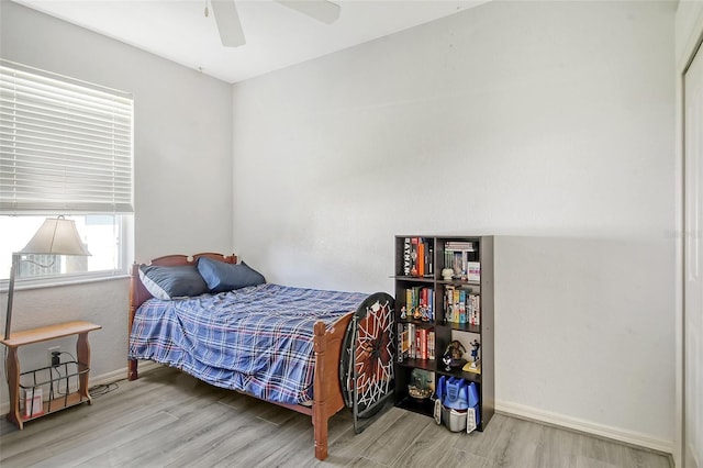 bedroom featuring hardwood / wood-style floors and ceiling fan