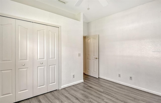 unfurnished bedroom with a closet, ceiling fan, and light hardwood / wood-style floors