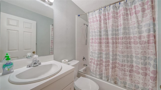 full bathroom with vanity, shower / bath combo, and toilet