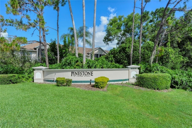 community / neighborhood sign with a lawn