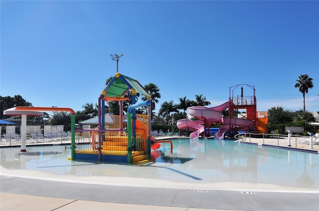 view of playground with a community pool