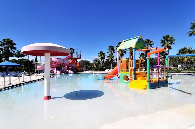 view of swimming pool featuring a playground