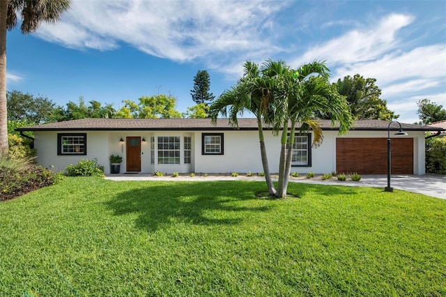 ranch-style home featuring a front lawn and a garage