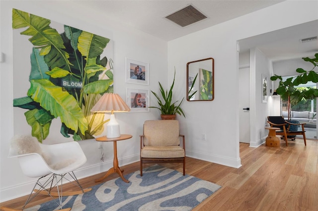 sitting room featuring wood-type flooring