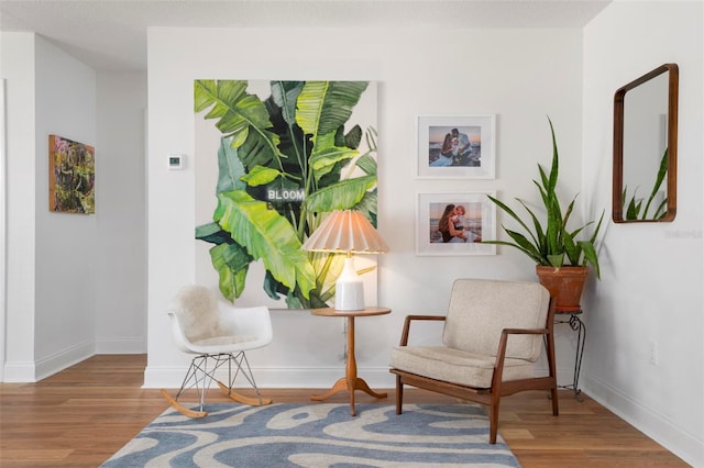 living area with hardwood / wood-style flooring