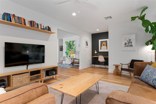 living room featuring ceiling fan and light wood-type flooring