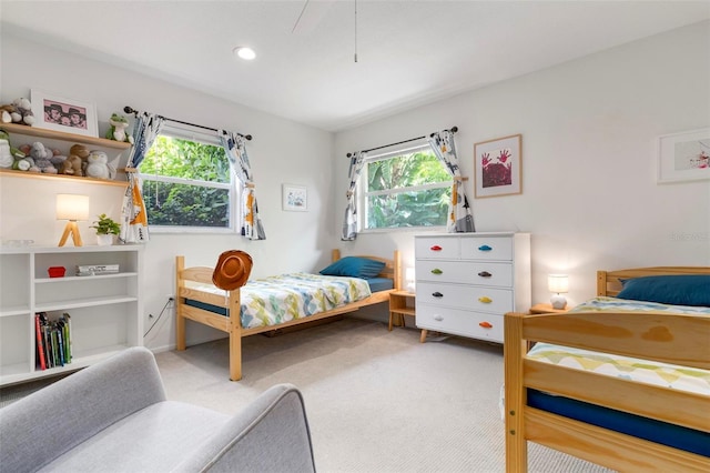 carpeted bedroom featuring multiple windows