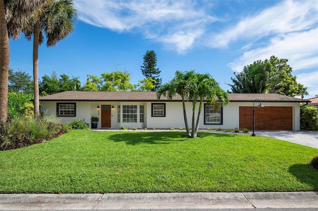 ranch-style house featuring a garage and a front lawn