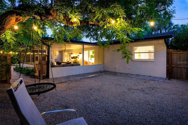 rear view of property featuring a patio area and a sunroom