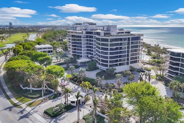 view of building exterior with a water view and a beach view