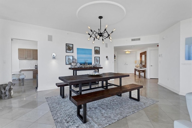 dining room with light tile patterned floors and a chandelier