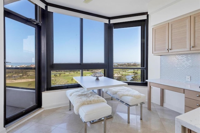 tiled dining room featuring a water view