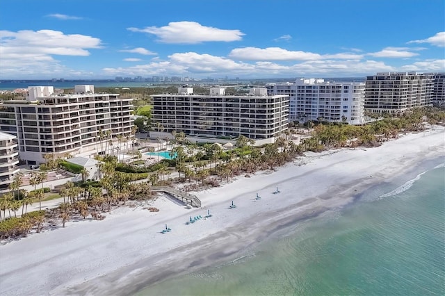 drone / aerial view featuring a water view and a view of the beach