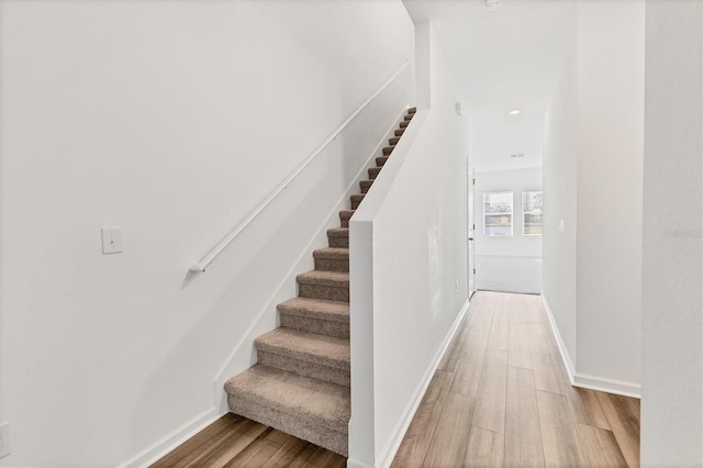 staircase with wood-type flooring