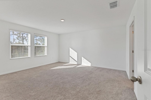 unfurnished room with light colored carpet