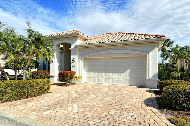 mediterranean / spanish-style home featuring a garage