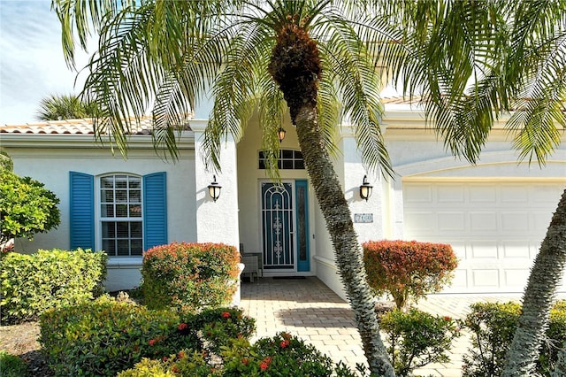 view of exterior entry with a garage