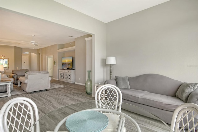 living room featuring ceiling fan and light hardwood / wood-style flooring