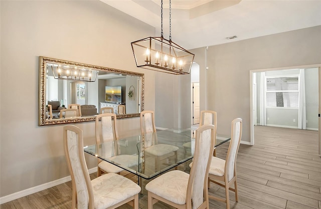 dining room with light wood-type flooring and ornamental molding