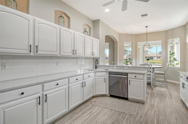 kitchen featuring white cabinetry, dishwasher, sink, backsplash, and decorative light fixtures