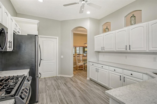 kitchen featuring ceiling fan, light hardwood / wood-style floors, white cabinetry, and tasteful backsplash