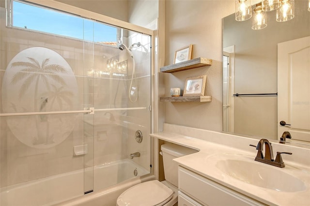 full bathroom with vanity, toilet, and bath / shower combo with glass door