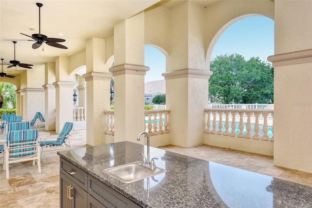 view of patio / terrace with ceiling fan and an outdoor wet bar