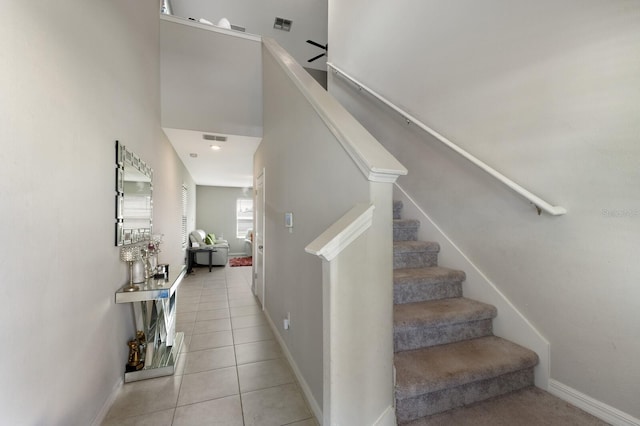 stairs featuring tile patterned flooring