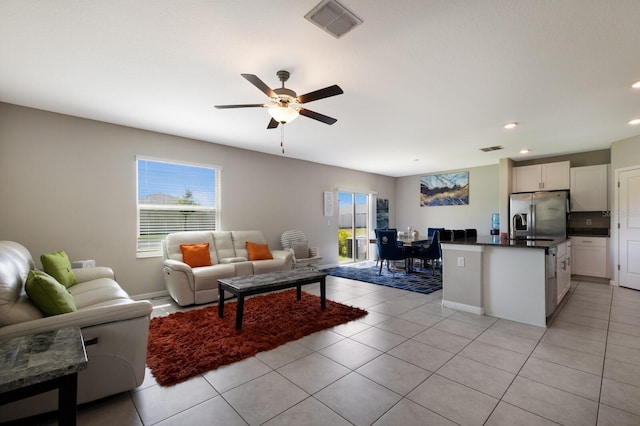 living room featuring ceiling fan and light tile patterned floors