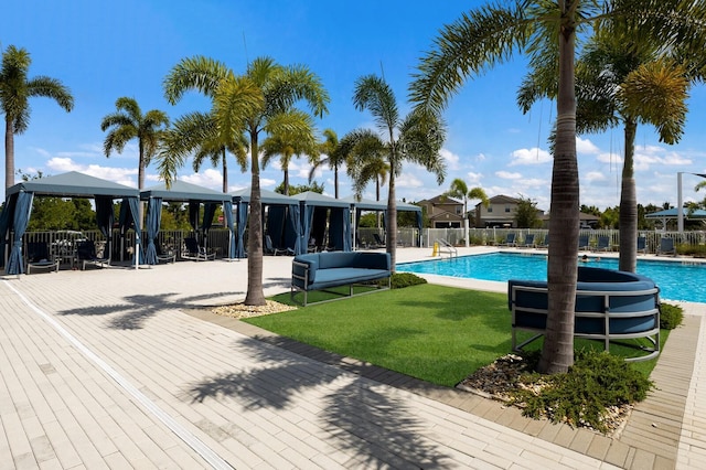 view of swimming pool featuring a yard